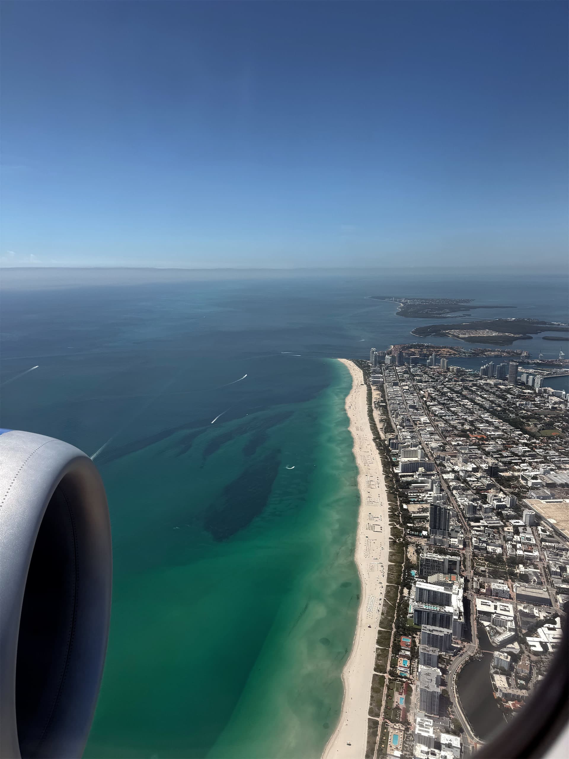 Aerial view of the Miami Beach coastline from an airplane window
